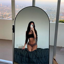 Model Mia in a Mirror Selfie with City View