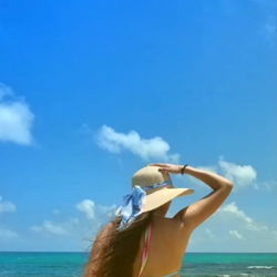 Woman in Hat and Bikini on Beach