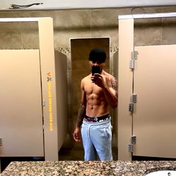 Model in Gym Bathroom Taking Selfie