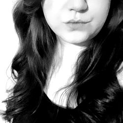 A woman with long hair, wearing a black top.