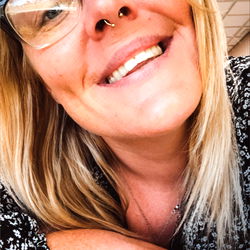 Woman in Glasses Smiling at Camera