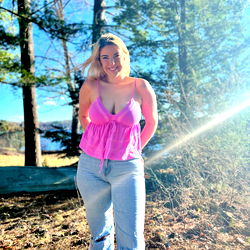 Model Dirty Dani in a Pink Tank Top and Jeans