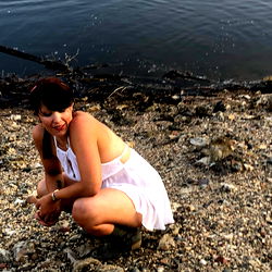 Female Model Squatting on the Beach