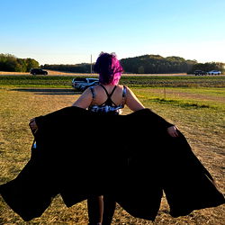 Model Alice in a Field, Displaying Dramatic Fashion Flair