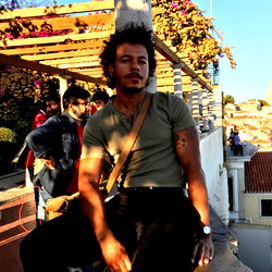 A Young Man Sitting on a Balcony in Lisbon, Portugal