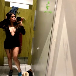 Elegant Model Strike a Pose in Retail Fitting Room