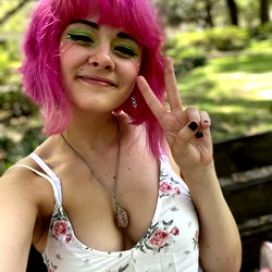 Leah, a vibrant model with pink hair and unique fashion sense.