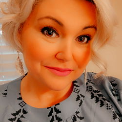 Woman in a Floral Blouse with Earrings