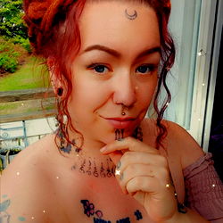 Fantasy-themed model showcasing a tattooed arm