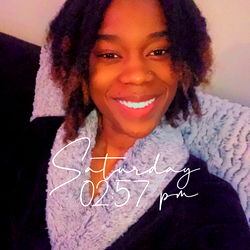 Model photo of a person in casual clothing, with a smile and relaxed pose.