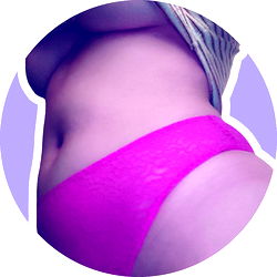 A striking photo of a model in a purple lingerie showcasing her physique.