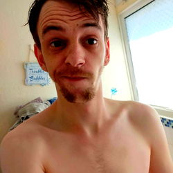 Young, Shirtless Man Making a Face for the Camera