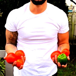 A Man Holding a Tomato and Pepper in Each Hand