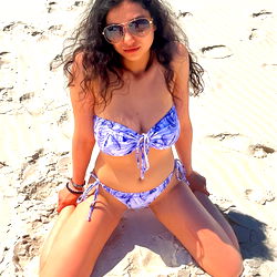 Stylish Bikini Model in a Relaxed Pose on the Beach