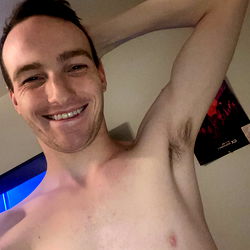 Shirtless Man in Tank Top Taking Selfie