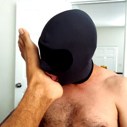 A humorous scene with a man in a mask and an unusual focus on his foot