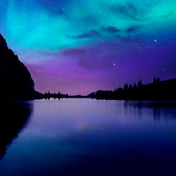 Stunning Aurora Borealis over a Calm Lake at Night