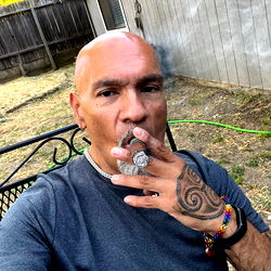 Pussyeater - Tattooed Man Enjoying Cigar with a Smile