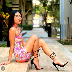 Young Female Model Sitting on Bench in City Street