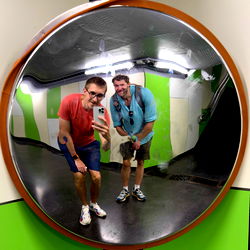Mirror Selfie of Two Men in Reflection