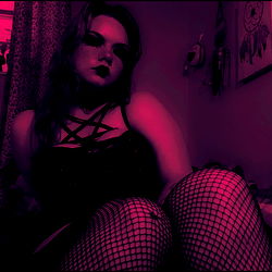 Vividly Dressed Gothic Model in Stylish Fishnet Stockings and Elegant Gothic Corset