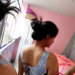 Alesso, Lima model showcasing a backless top and casual hairdo