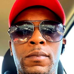 A Man in Sunglasses and a Red Hat