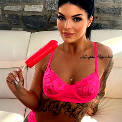 OnlyFans Model Auudreyxo Striking a Confident Pose with Pink Lingerie and Popcycle