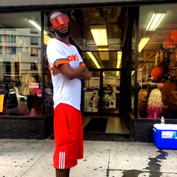 Nosaj, a model and actor from New Jersey, showcasing urban fashion in the street.