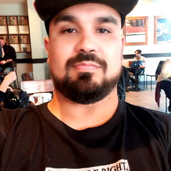 DavidV35 - 40-year-old male from Los Angeles CA with a beard and a humorous sign on his shirt