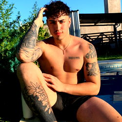 Zayn Reed - Bodybuilder with Tattoos Sitting by Pool