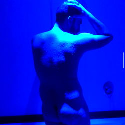 Onlyfans model Alberto García, photographed in blue lighting.