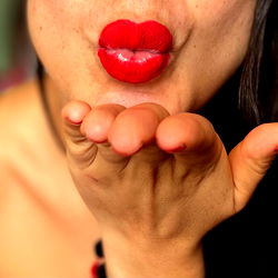 A sultry OnlyFans model sharing a kiss with the camera