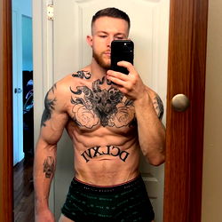 Rocky, Famous OnlyFans Model, Striking Pose in His Tattooed Gym Body