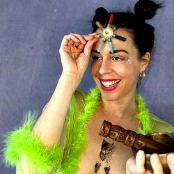 A model in a colorful outfit showcasing her makeup skills and confidence in front of the camera.