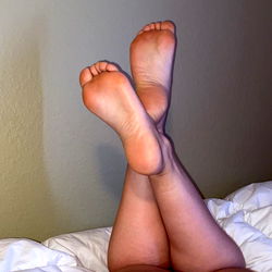 Feet in Pajamas on Bed