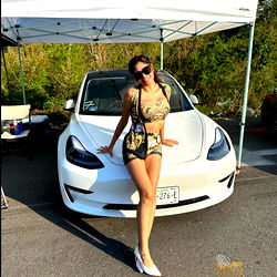 Alesita Bombon, an Instagram model posing by a car
