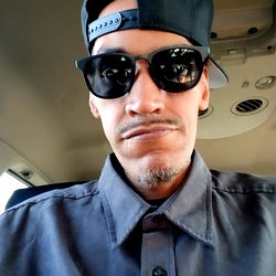 Idkwtf2do - A Man in a Cap and Sunglasses, Standing in a Vehicle