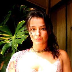 Darby, a young adult woman with shoulder-length hair and a piercing