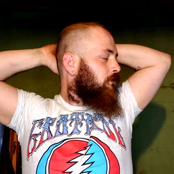 Strong-looking Bearded Man in Sage and King T-shirt