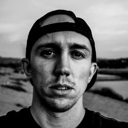 Portrait of a young adult male with a beard and short hair, looking towards the camera.