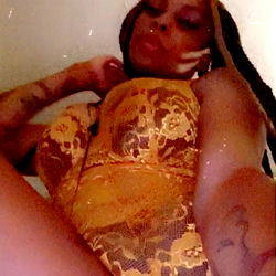 OnlyFans Model Splash God in an Elaborate Dress with Tattoos and Extensions