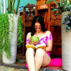A tranquil outdoor scene with a woman enjoying a book