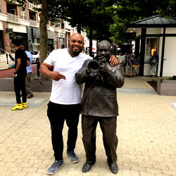 A Celebratory Encounter Between a Man and an Iconic Statue