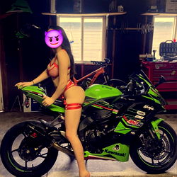 Model Anastalia Kova Poses With KTM Motorcycle in Garage