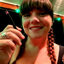 Woman in a relaxed setting holding a vape pen