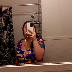 A Woman Taking a Mirror Selfie in a Bathroom