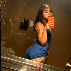 Attractive young woman with striking features in a bathroom mirror