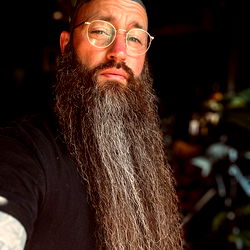 Bearded Man with Tattoos, Glasses and a Mustache,