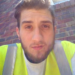 A construction worker posing for a picture